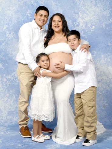 Happy family celebrating pregnancy with smiles.