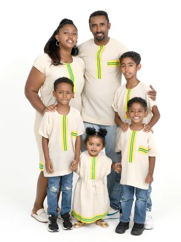 Family portrait in matching outfits with yellow-green accents.