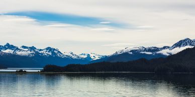 Scenic Alaska landscape with snow-capped mountains in the background.