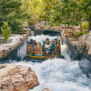 Mystic River Falls at SDC, featuring a large wooden flume ride winding down the rapids.