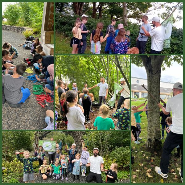 Children and adults engaging in outdoor educational activities in a forest setting.