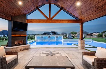 Custom cedar patio cover and outdoor fireplace installation in Plano, Texas