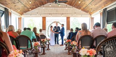 Husband and Wife during the ceremony holding hands on the westside of Spartanburg South Carolina