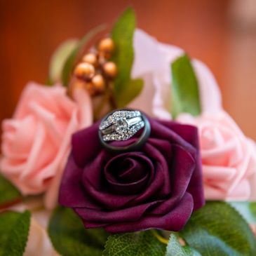 Wedding rings sitting on flowers. Photo by Grace & Lace Studios Spartanburg South Carolina.