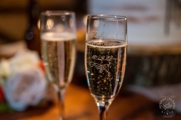 Champagne glasses filled wth Champagne with wedding date on them at Biship Farms in Inman SC