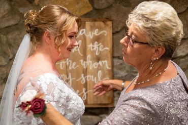 Mom adjusting brides Wedding Dress while getting ready before Ceremony at Pretty Place Chapel
