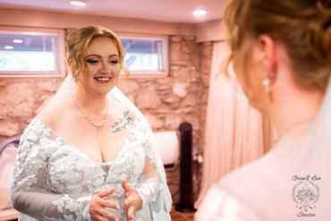 Bride looing at herself in the mirror while getting ready for her wedding at Pretty Place Chapel