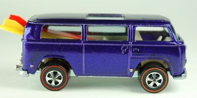 Purple toy van with surfboards in the back.