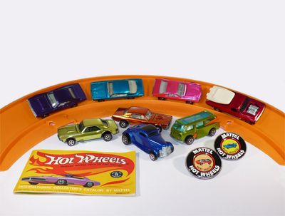 Collection of vintage Hot Wheels cars and accessories.