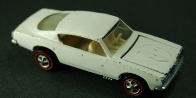 White toy car with redline wheels.