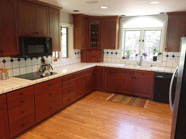 Kitchen counter flooring tile back splash appliances lighting cabinets molding wood LVP granite tile