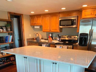 Kitchen counter flooring tile back splash appliances lighting cabinets molding