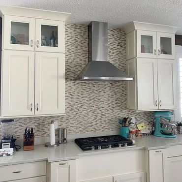 Kitchen Vent hood counter flooring tile back splash appliances lighting cabinets molding wood LVP