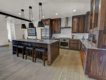 Kitchen counter flooring tile back splash appliances lighting cabinets molding wood LVP granite tile