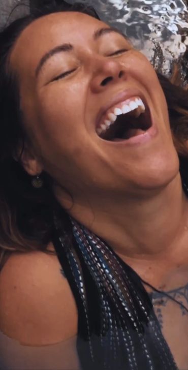 Woman above water mouth open freely expressing joy or laughter