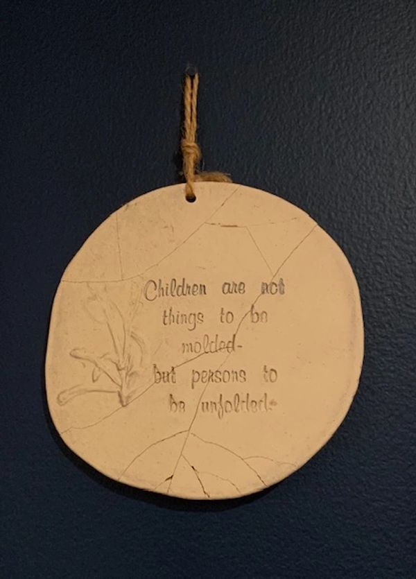 Children unfolding plaque