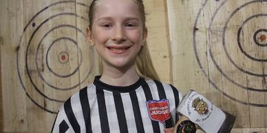 10 year old with an axe demonstrating axe throwing technique