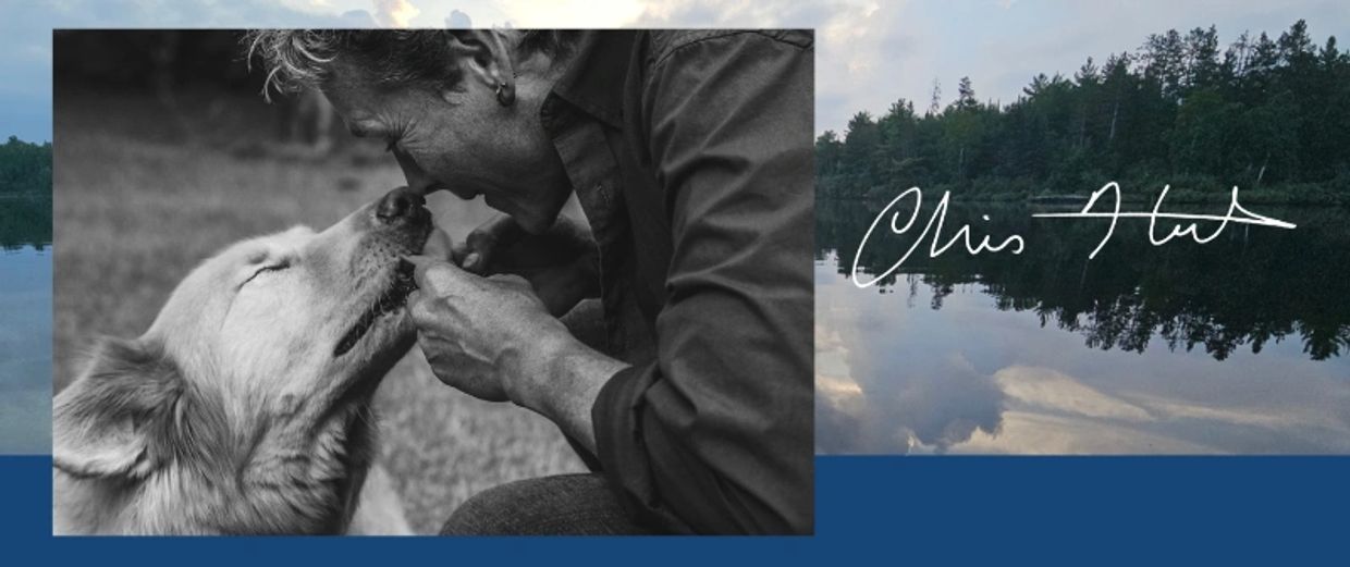 Man bonding with dog in black and white photo.