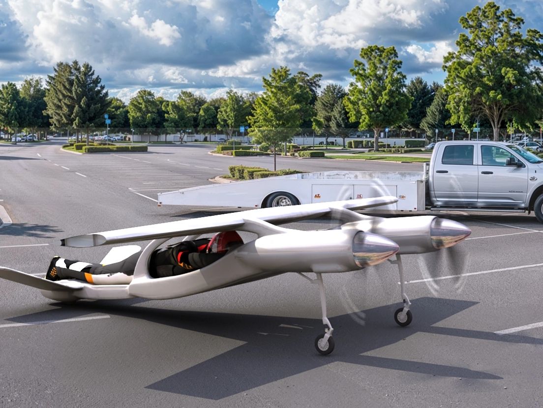 A small futuristic aircraft parked in a lot with a driver inside.