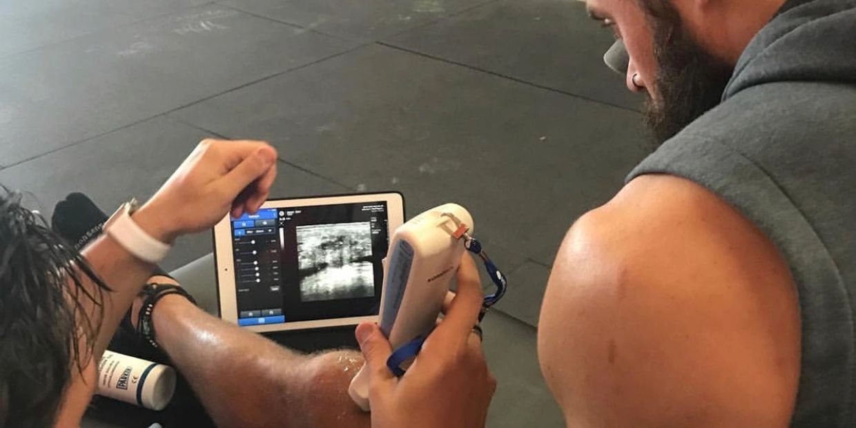 Dr. Rosi using portable ultrasound on patients left knee