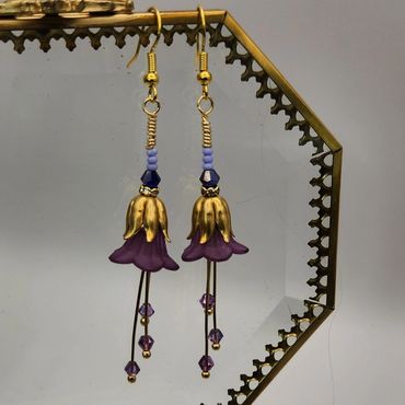 Two bell drop earrings with blue and purple accent colors