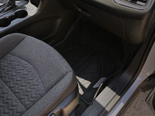 Interior of a car showing a seat and floor mat.