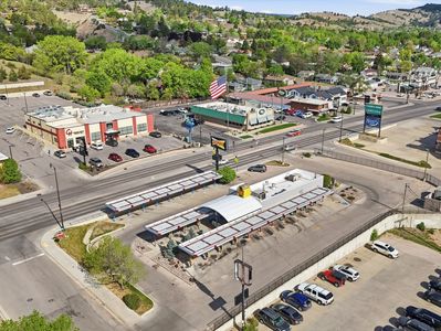 Aerial view of a car wash and commercial buildings.