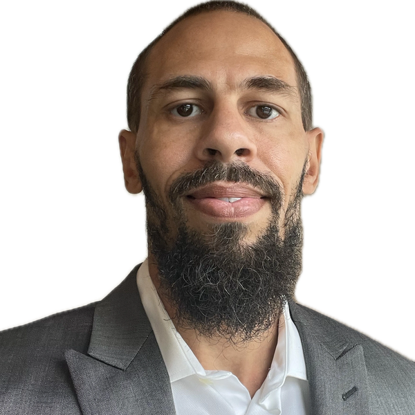 CEO Kyle Keyes with a beard in a gray suit jacket and white shirt.