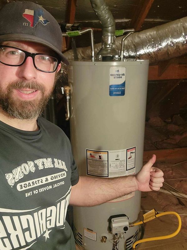 Plumber water heater installer finishing a gas water heater install in Plano Texas