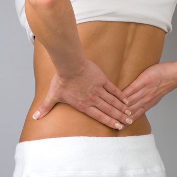 Person holding lower back in pain.