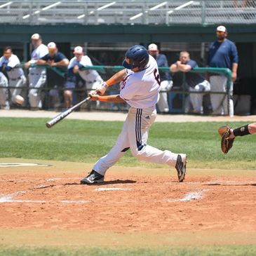 Baseball player hitting the ball during a game.