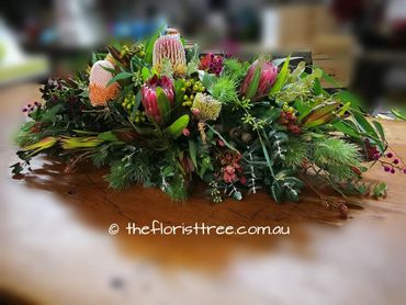 Australian and South African native funeral flowers in a casket spray created by a qualified florist