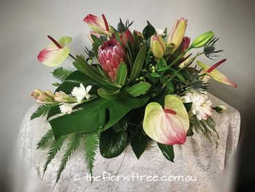 Funeral topper of exotic flowers created by a qualified florist