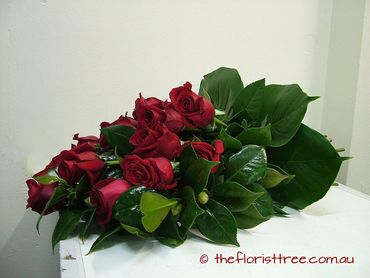 Red rose funeral sheaf of flowers created by a qualified florist at The Florist Tree