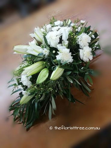 White funeral sheaf of flowers  created by a qualified florist at The Florist Tree