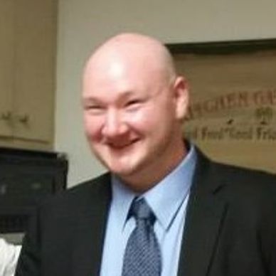 A smiling bald man