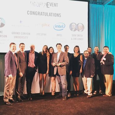 yesPHX group of 12 people on stage receiving award from GPEC