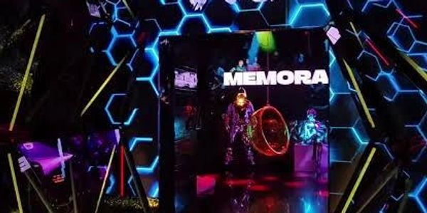 Futuristic room with glowing hexagons and neon lights.