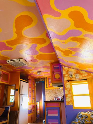 Fully custom renovated RV at a California desert resort. Themed and colored to match the sunrises.