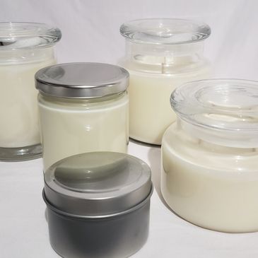 variety of glass and tin candle jars