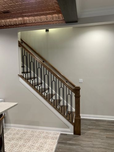 Interior stairs with wood and metal railing.