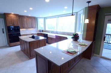 Granite counters and island in a large kitchen.