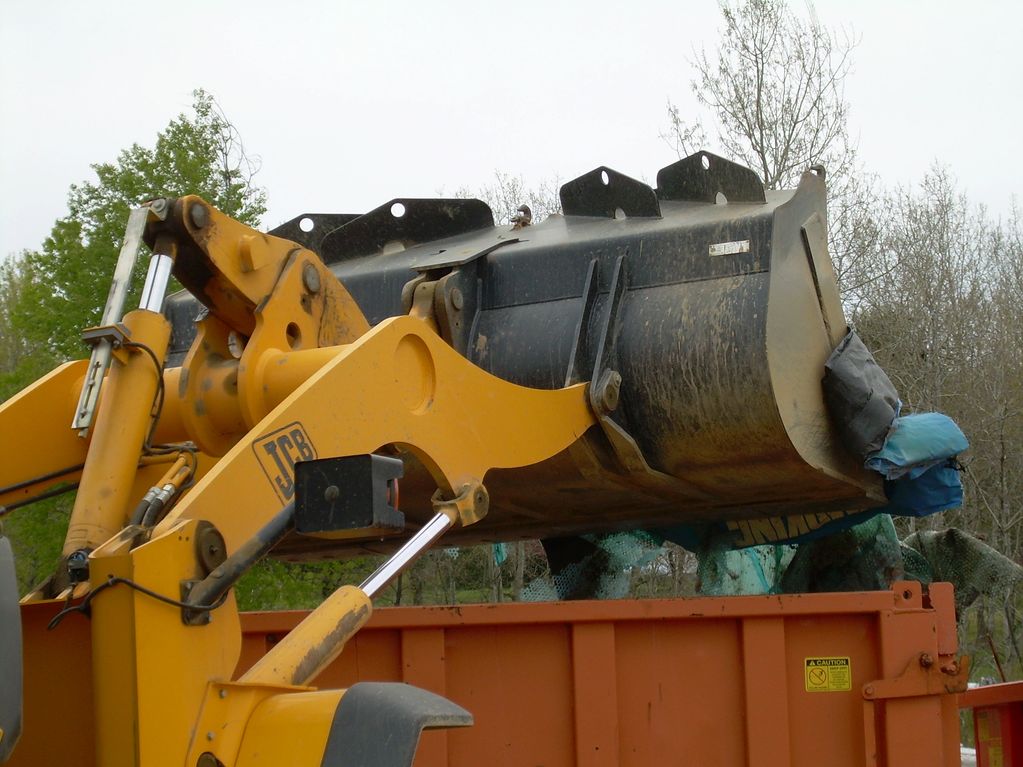 Putting items from Clean Day in the Dumpster