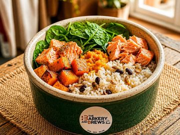 Healthy bowl with salmon, rice, spinach, and sweet potatoes.