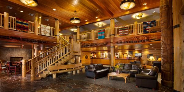 Cozy rustic lodge interior with wooden beams and leather seating.