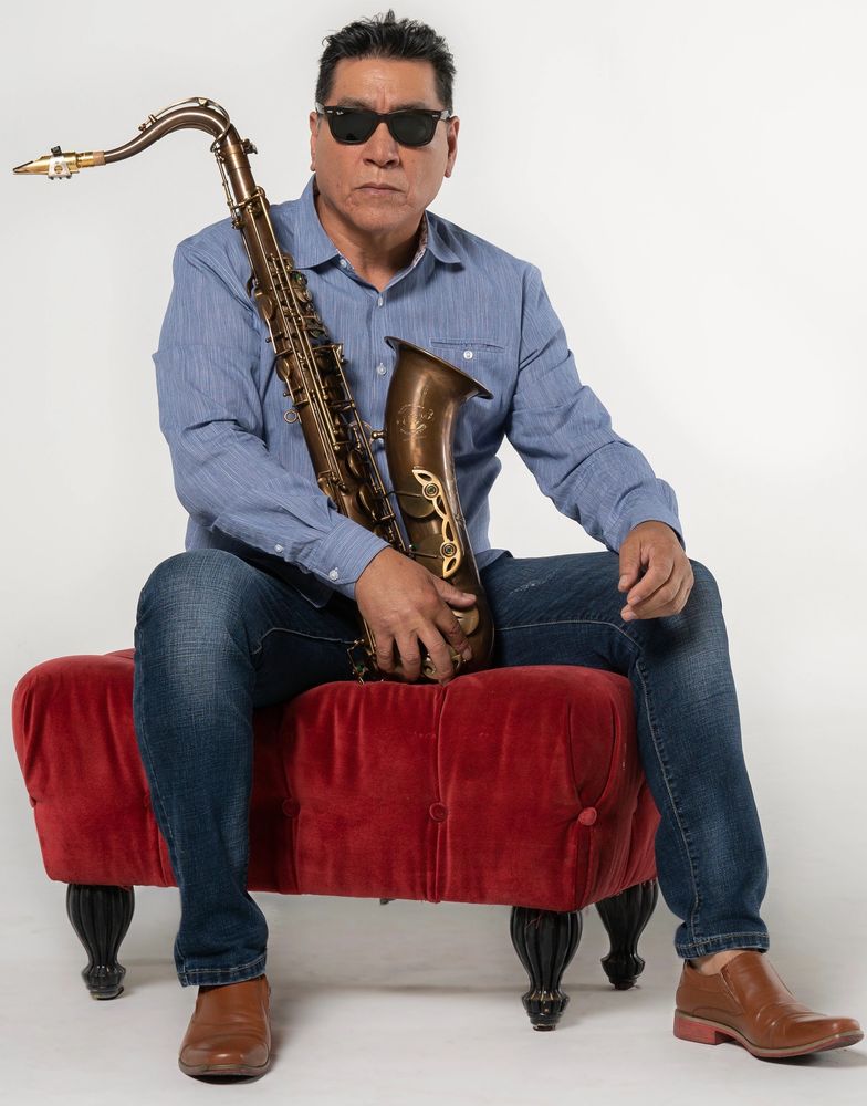 Tommy Alvarado holding a GTsax tenor saxophone.