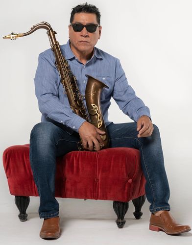 Tommy Alvarado holding a GTsax tenor saxophone.