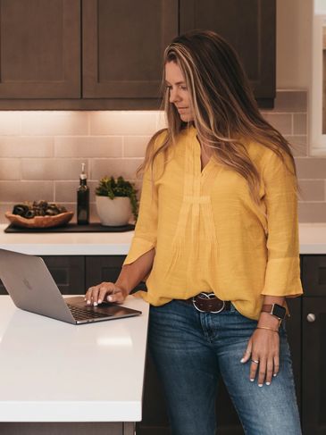 image of your realtor working on their laptop in a kitchen