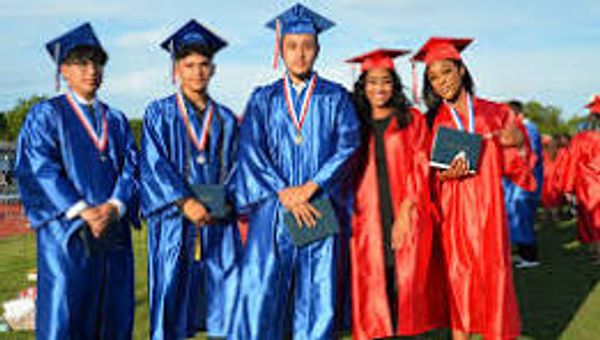 Five graduates in blue and red gowns posing outdoors with medals and diplomas.
