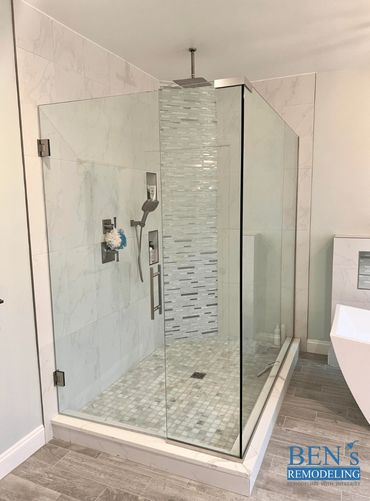 a remodeled bathroom by BEN's Remodeling with a stand-up ceiling shower, niche , glass enclosure